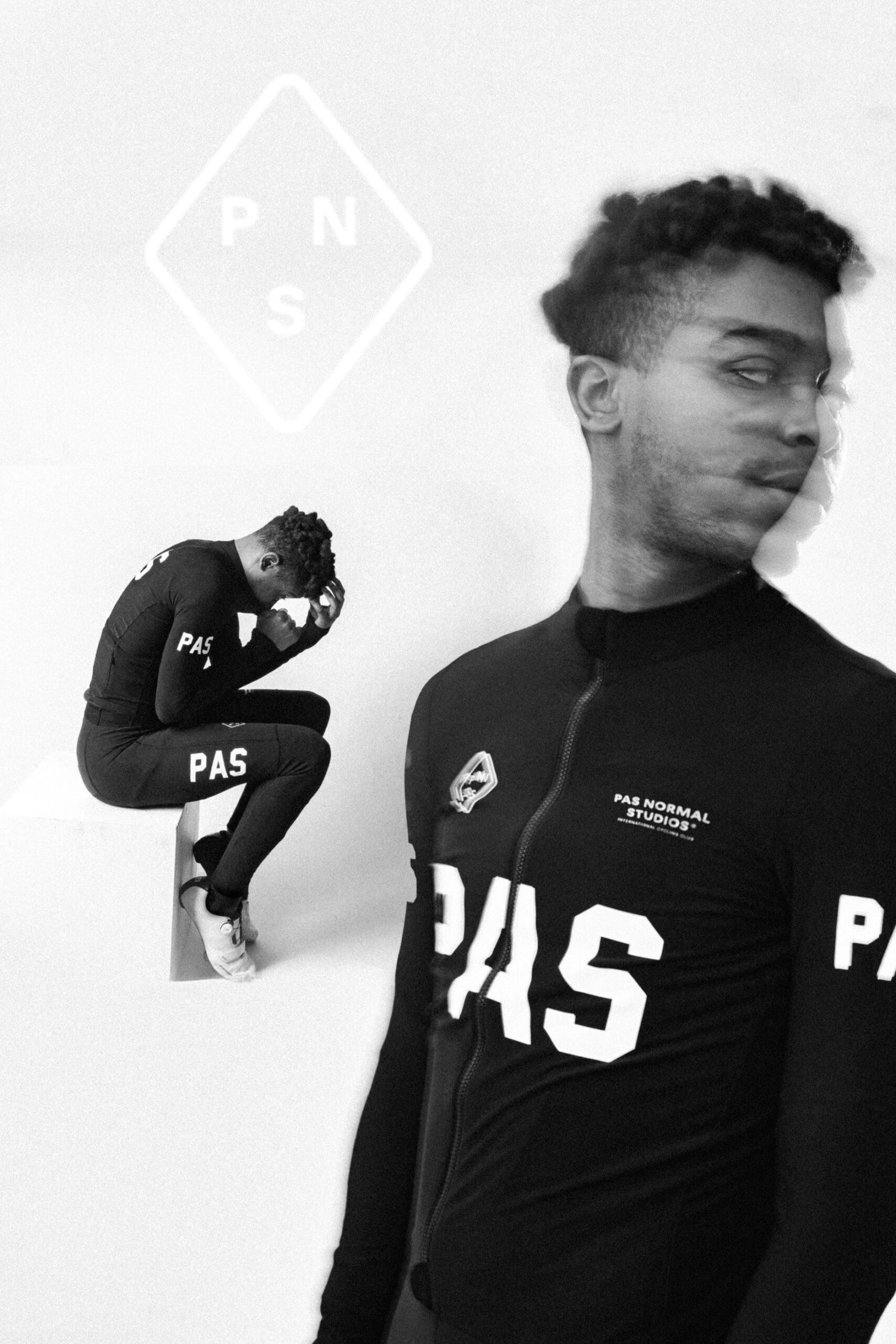 A black and white image showing a cyclist in PAS apparel. One side features him sitting, head in hands, in a racing suit. The other side shows him standing, with a blurred motion effect. A logo with "PNS" appears above.